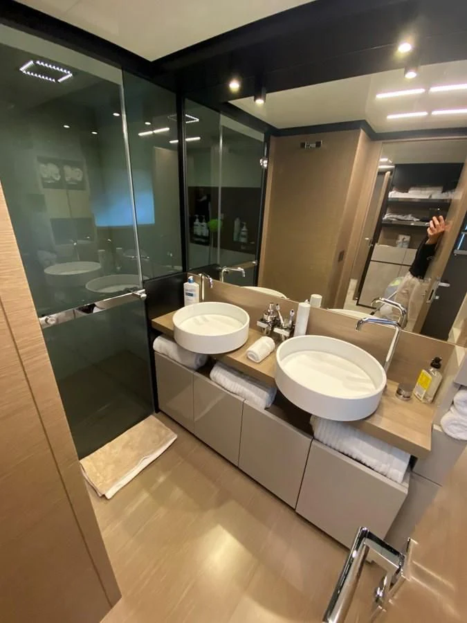 a bathroom with a large mirror aboard SUNSATION Yacht for Sale