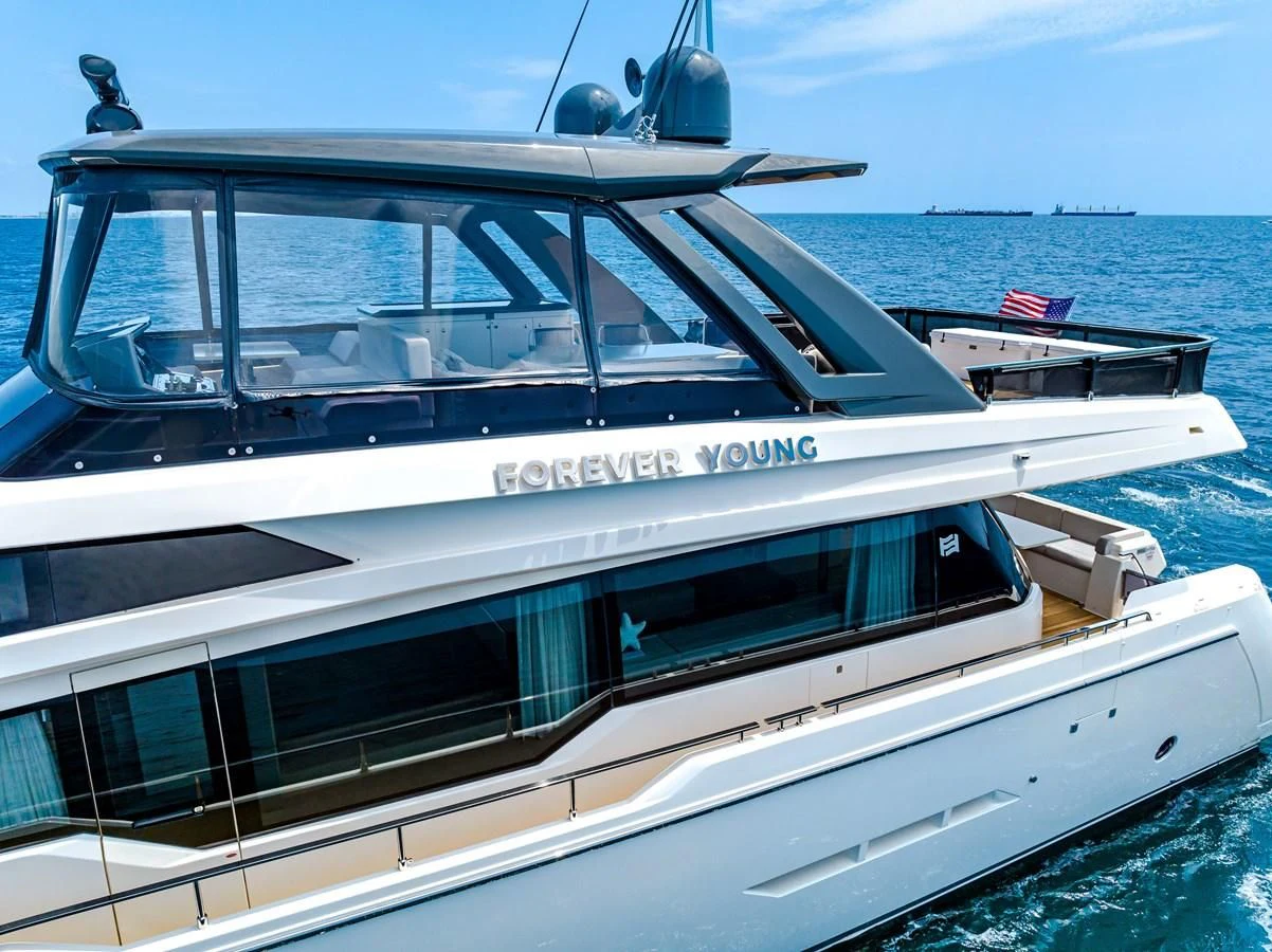 a white boat on the water aboard SUNSATION Yacht for Sale