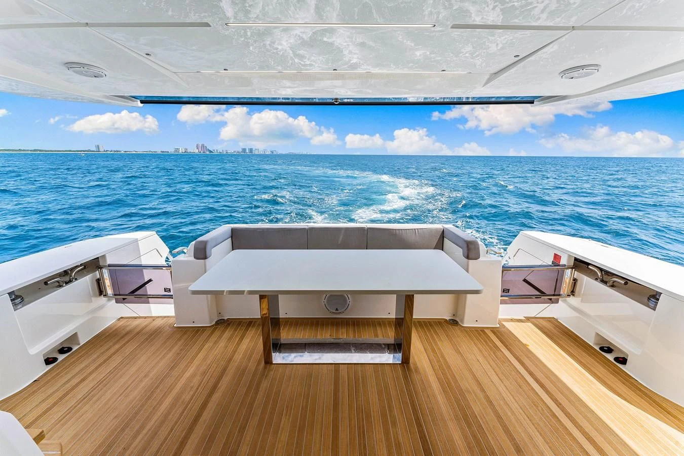 a wooden deck overlooking a body of water aboard SUNSATION Yacht for Sale