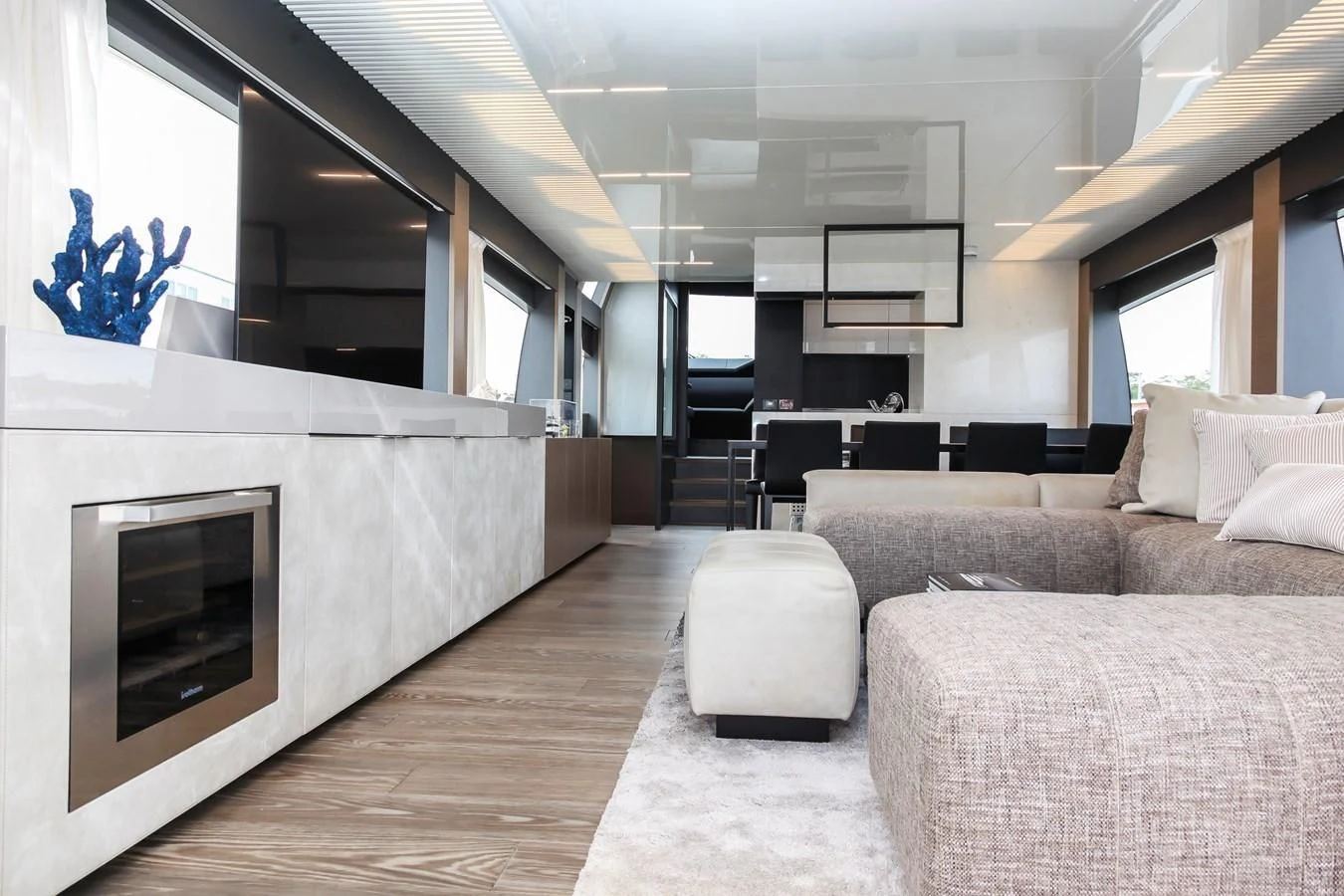 a living room with a fireplace aboard SUNSATION Yacht for Sale