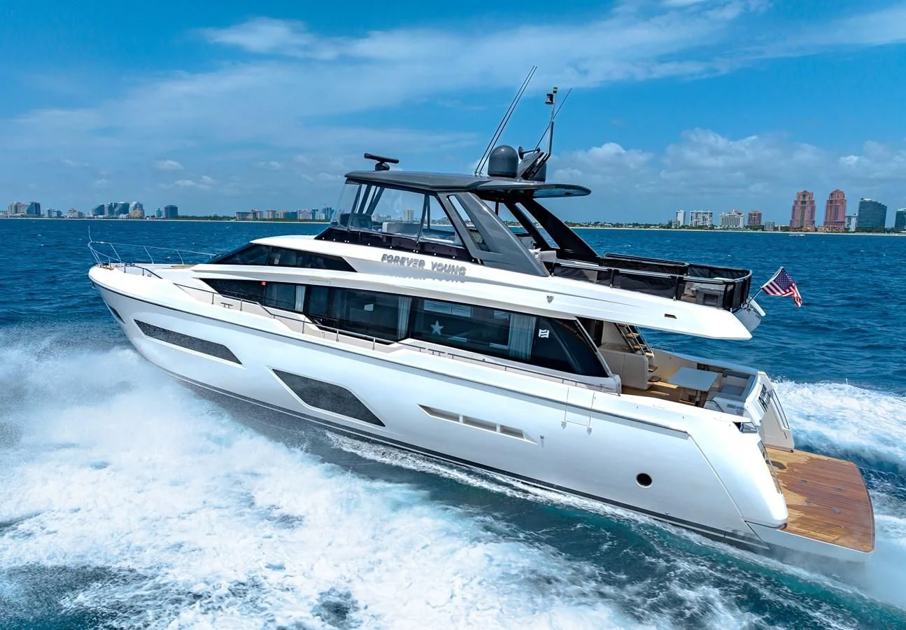 a white yacht on a body of water aboard SUNSATION Yacht for Sale