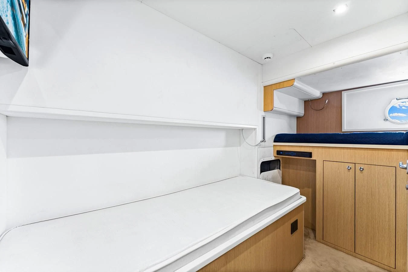 a white room with wooden cabinets aboard SUNSATION Yacht for Sale