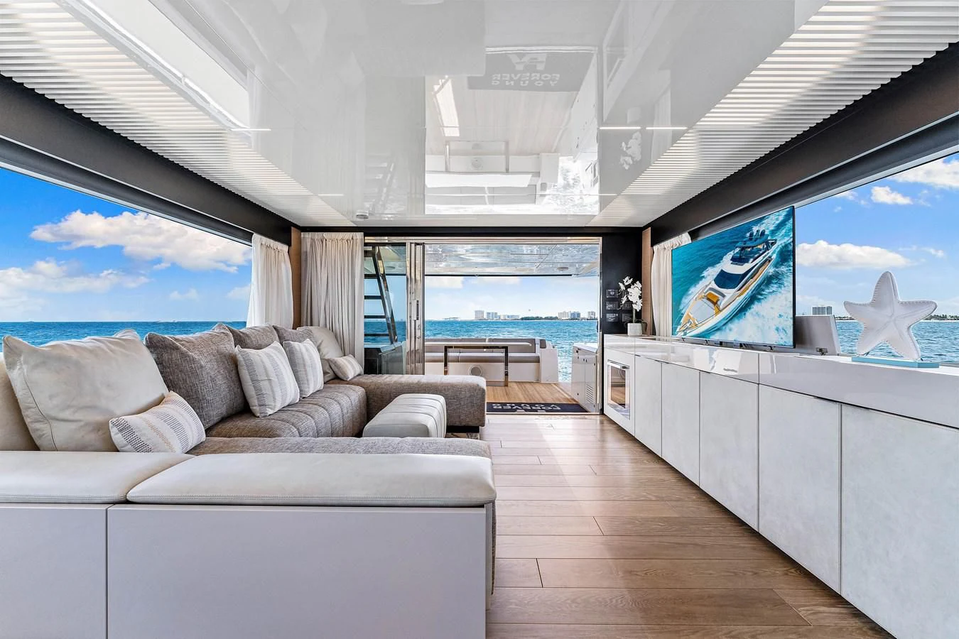 a living room with a large window aboard SUNSATION Yacht for Sale