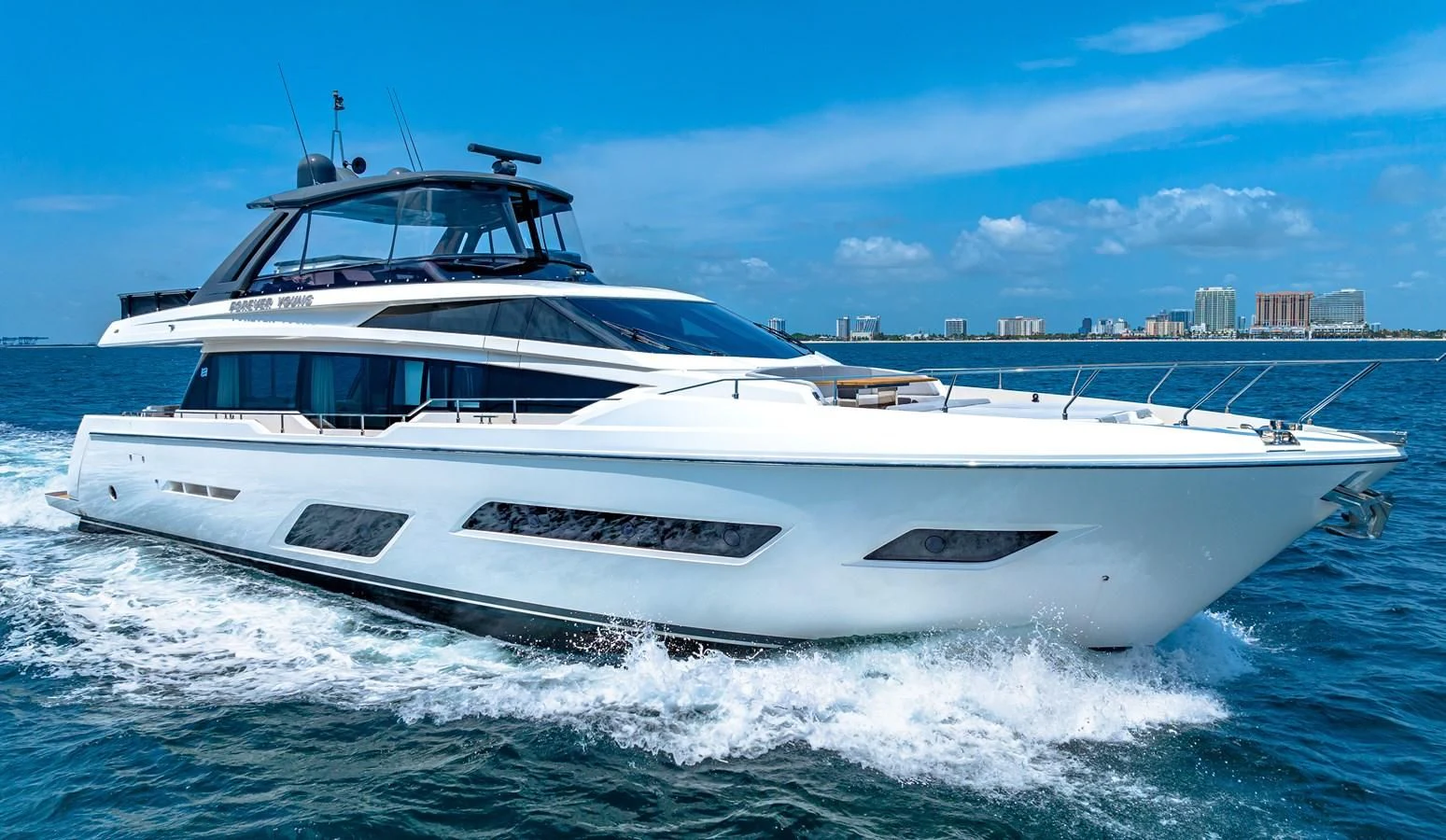 a white yacht on the water aboard SUNSATION Yacht for Sale
