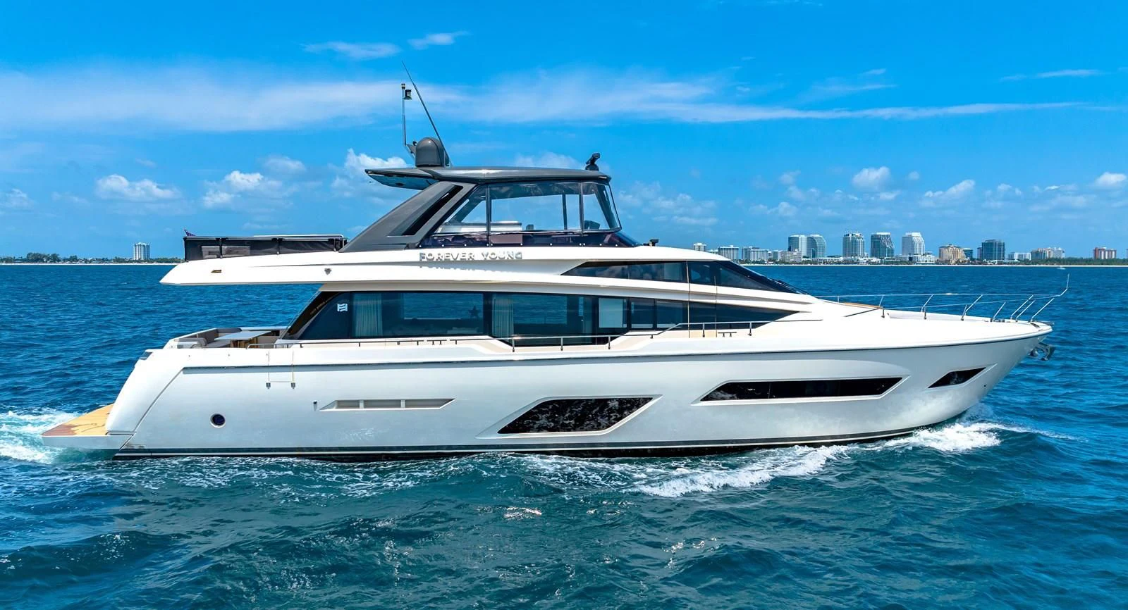 a white yacht in the water aboard SUNSATION Yacht for Sale
