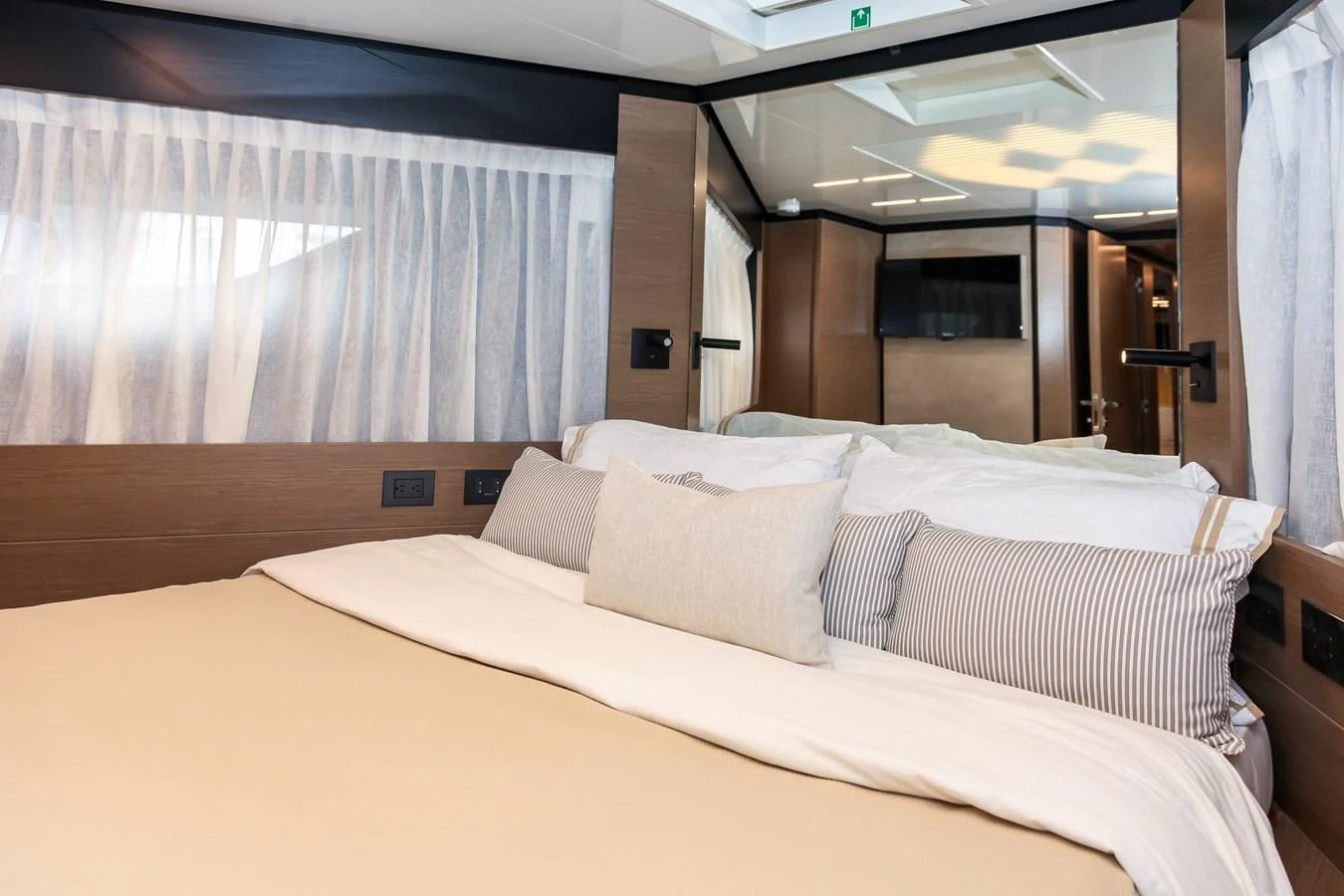 a bed with white sheets aboard SUNSATION Yacht for Sale