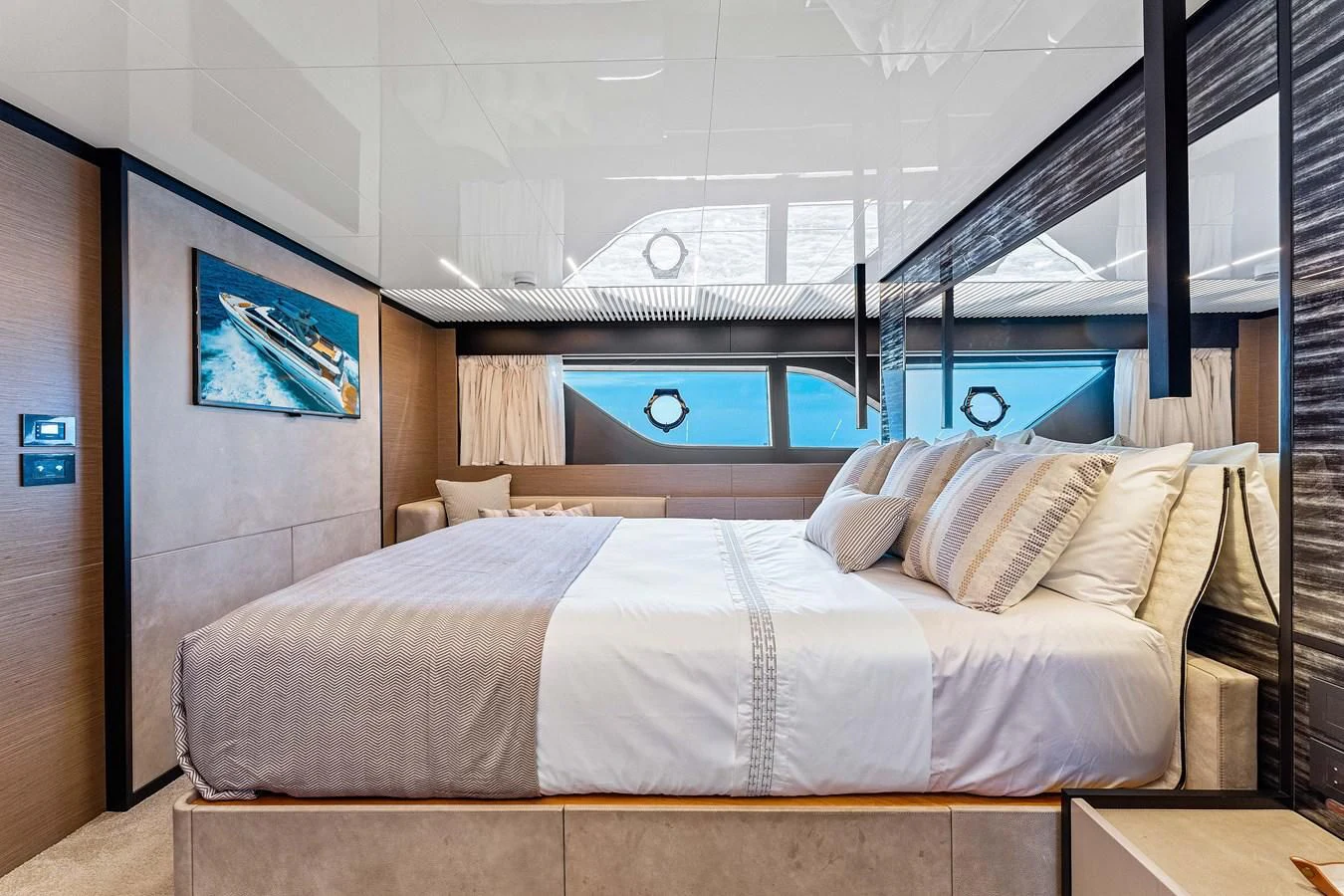 a bed with a white sheet and a blue headboard aboard SUNSATION Yacht for Sale