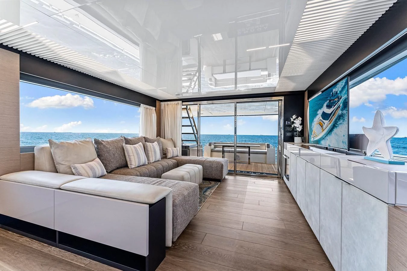 a living room with a large window aboard SUNSATION Yacht for Sale