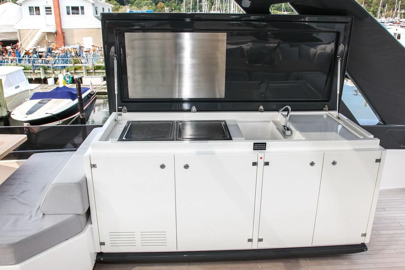 a white kitchen with a sink aboard SUNSATION Yacht for Sale