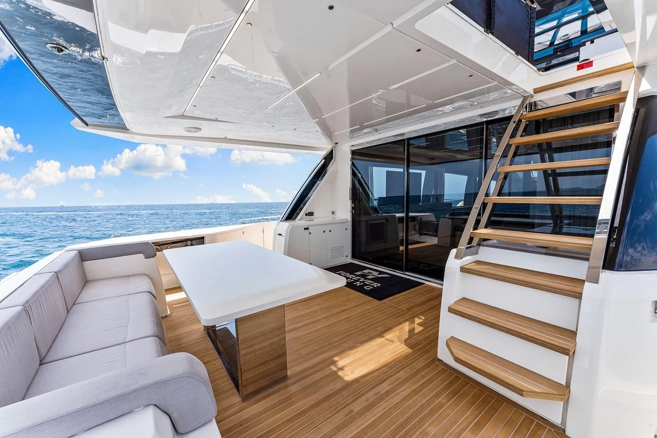a room with a table and chairs aboard SUNSATION Yacht for Sale
