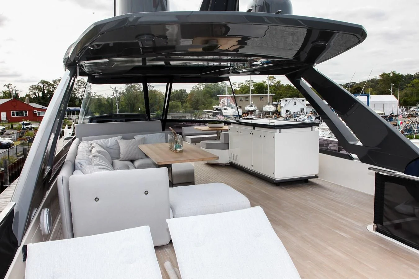 a room with a couch and a table and a large window aboard SUNSATION Yacht for Sale