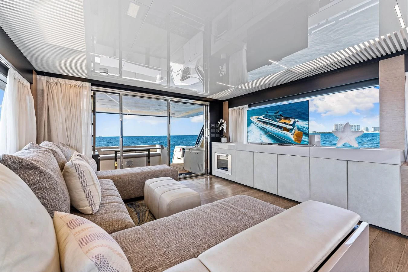 a living room with a large window aboard SUNSATION Yacht for Sale