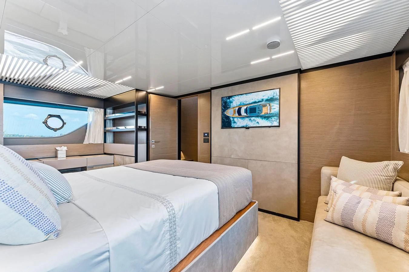 a room with a bed and a television aboard SUNSATION Yacht for Sale