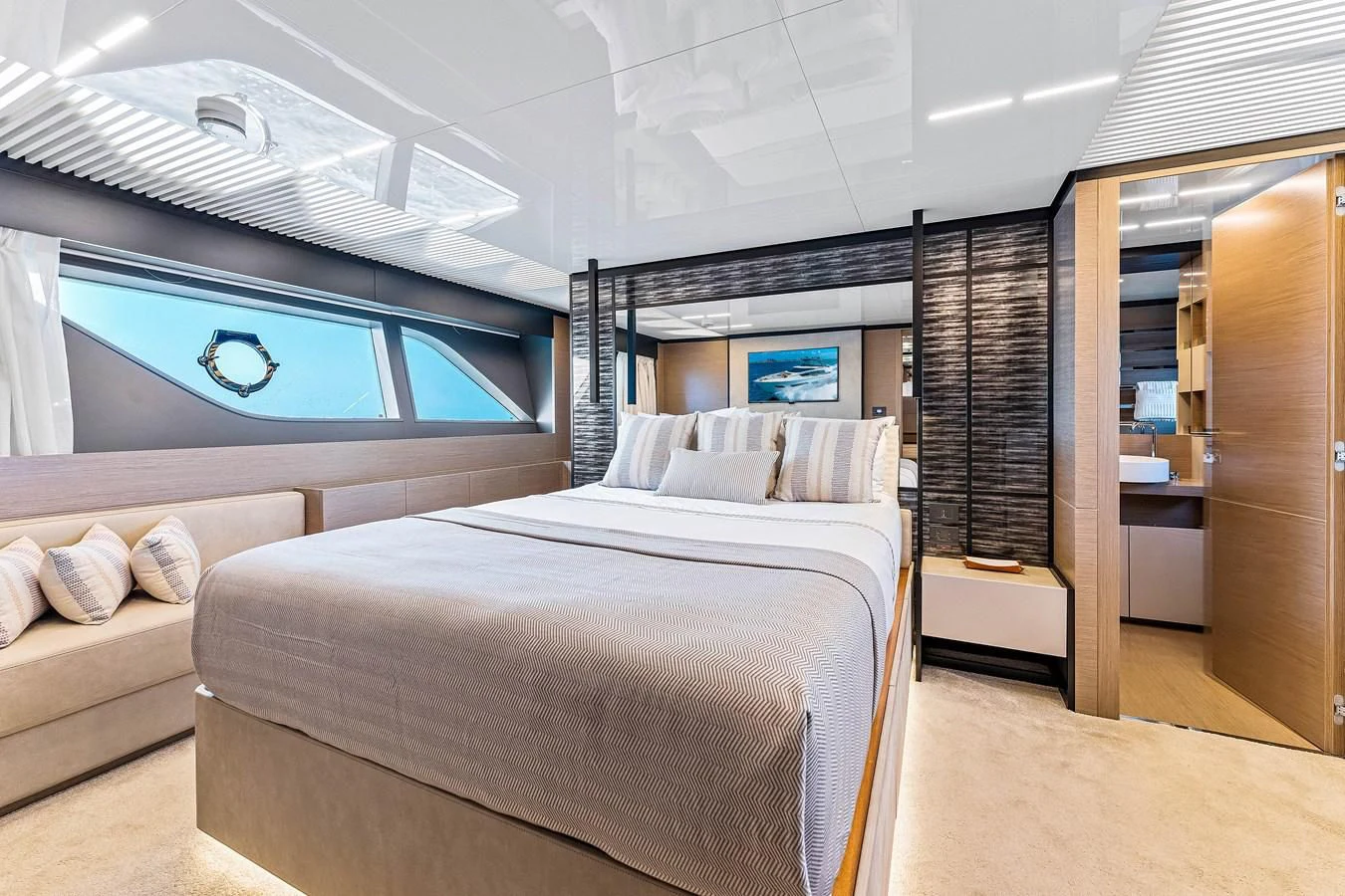 a room with a bed and a couch aboard SUNSATION Yacht for Sale