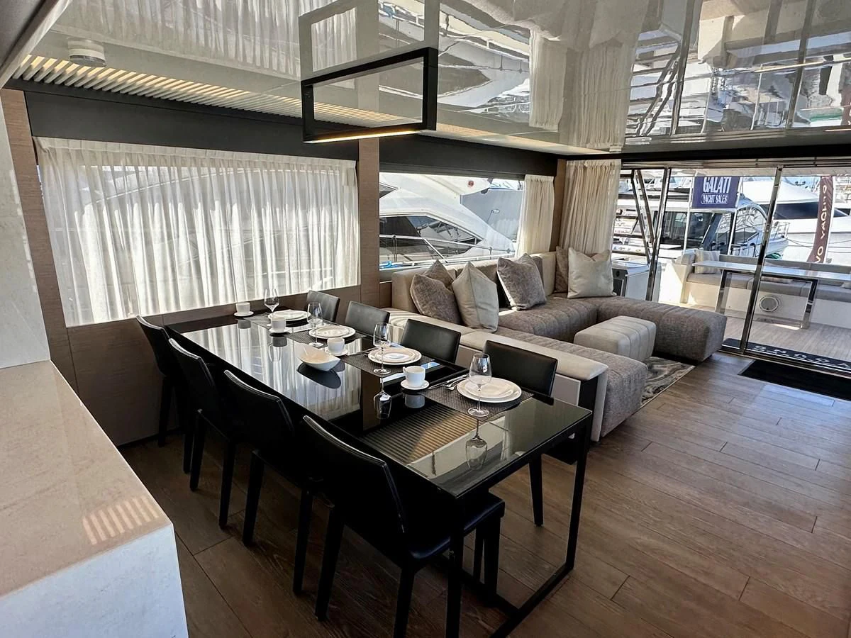 a room with a couch and a table with chairs aboard SUNSATION Yacht for Sale