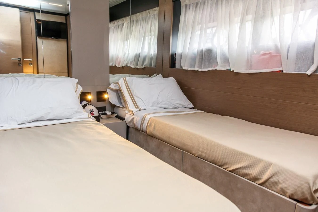 a couple of beds in a hotel room aboard SUNSATION Yacht for Sale