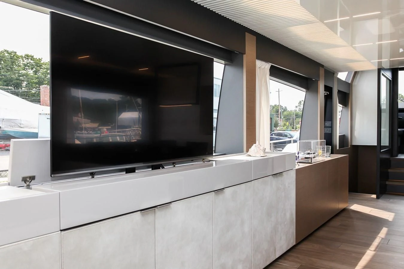 a room with a large window and a wood floor aboard SUNSATION Yacht for Sale