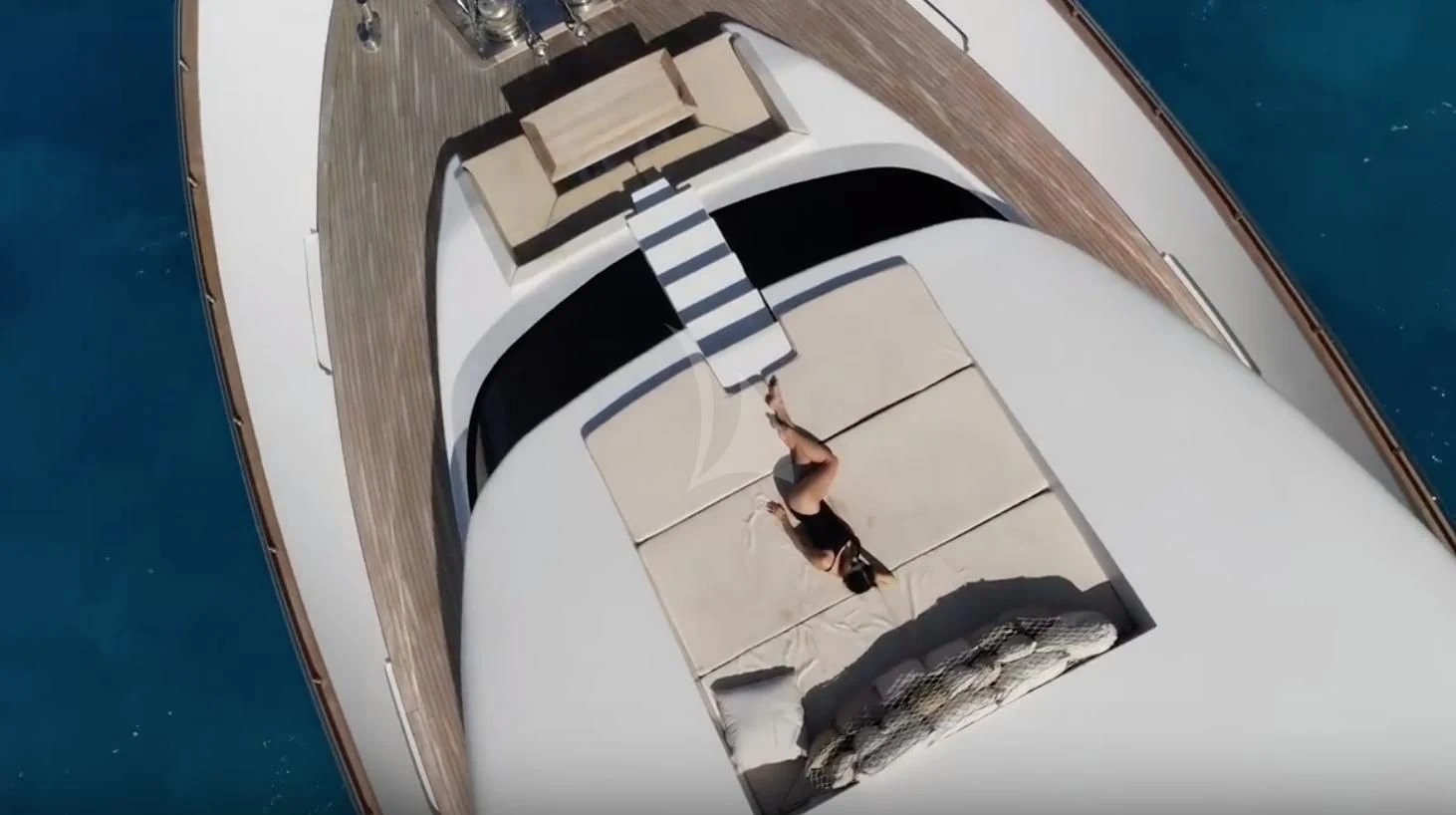 a person standing on a white and black floor with a white and black tile floor and a blue aboard VILLA SUL MARE Yacht for Sale