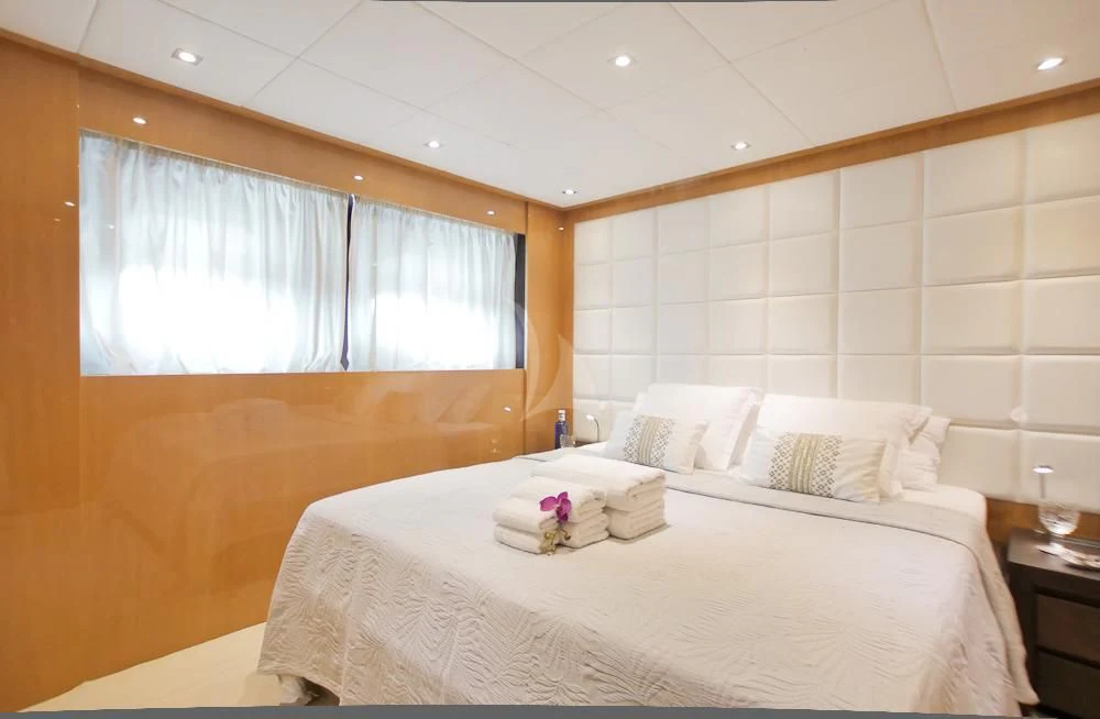 a room with a bed and a window aboard VILLA SUL MARE Yacht for Sale