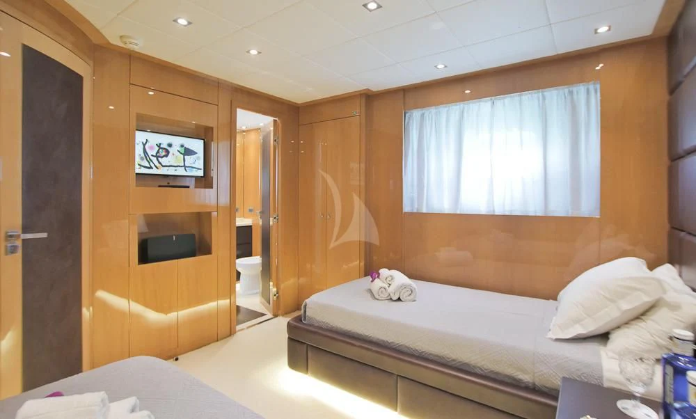 a room with a bed and a television aboard VILLA SUL MARE Yacht for Sale