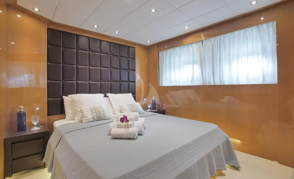 a room with a bed and a window aboard VILLA SUL MARE Yacht for Sale