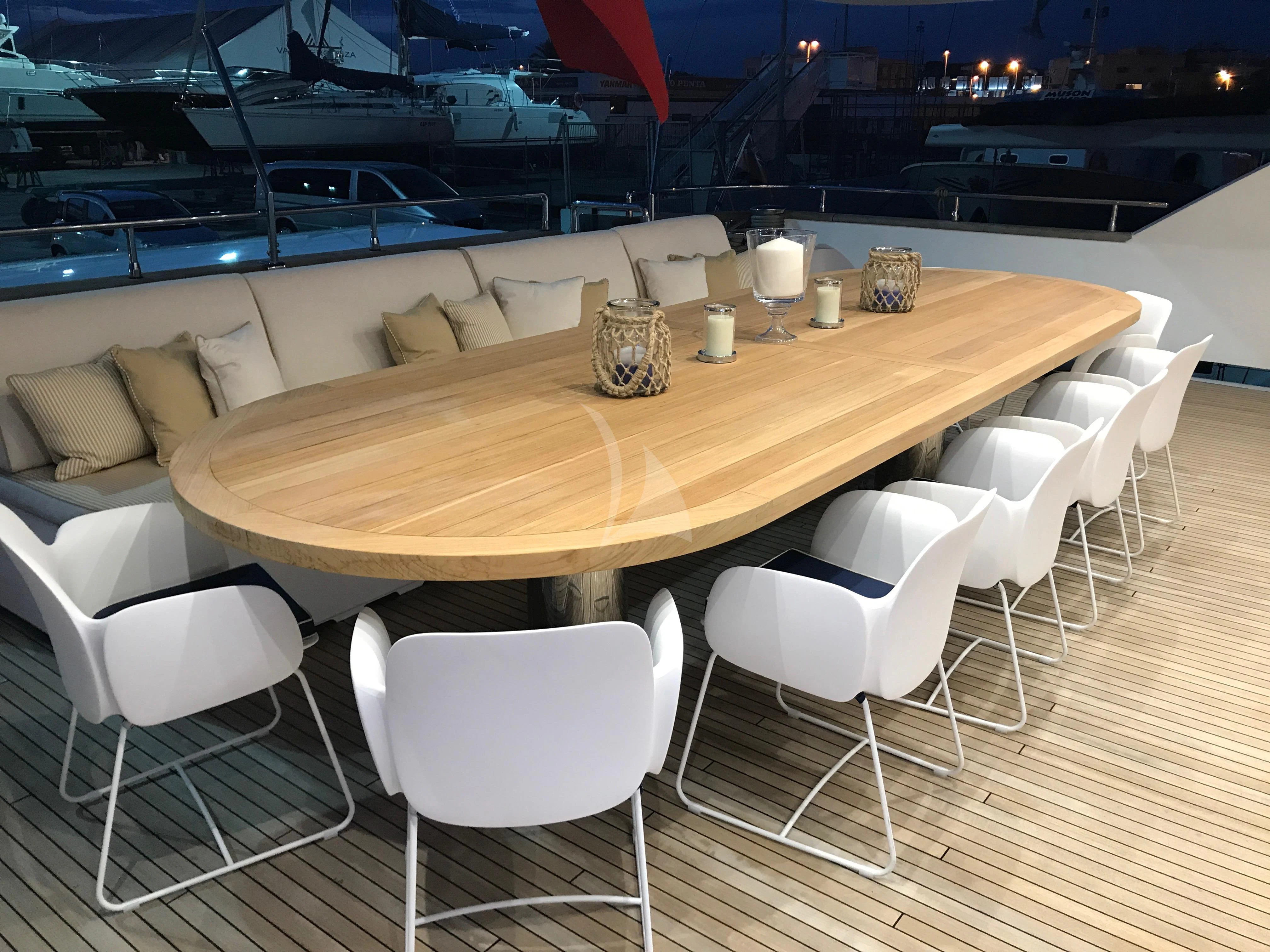 a table with chairs around it aboard VILLA SUL MARE Yacht for Sale