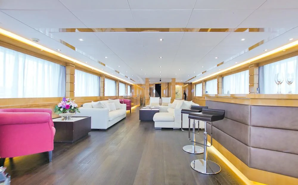 a room with a table and couches aboard VILLA SUL MARE Yacht for Sale