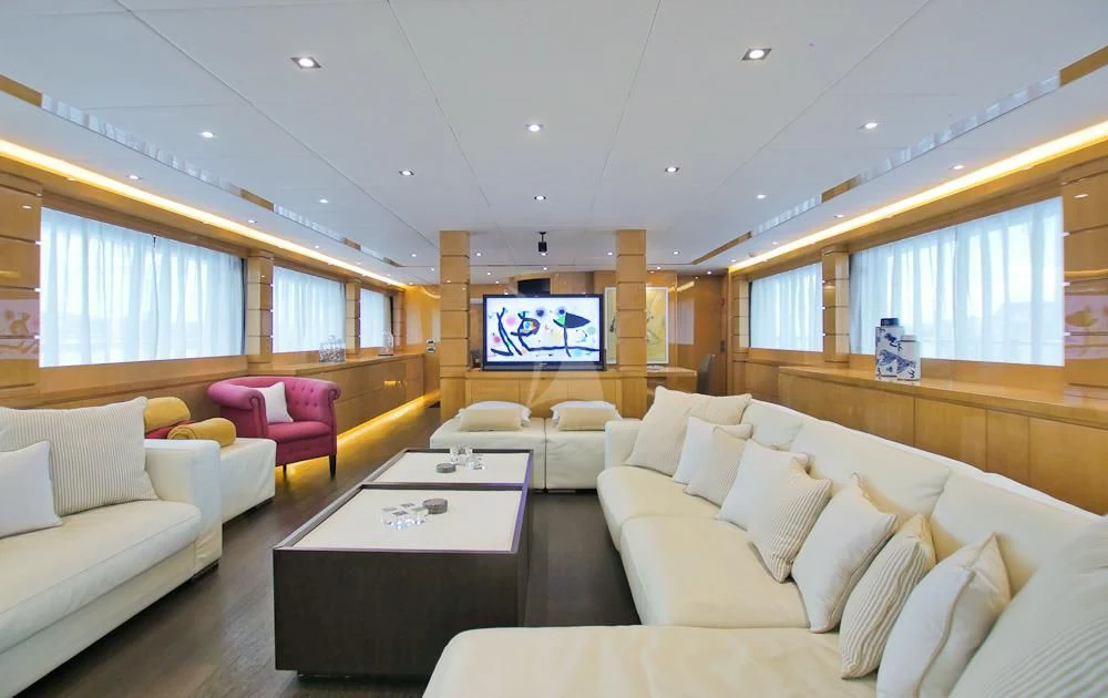 a living room with a table and couches aboard VILLA SUL MARE Yacht for Sale