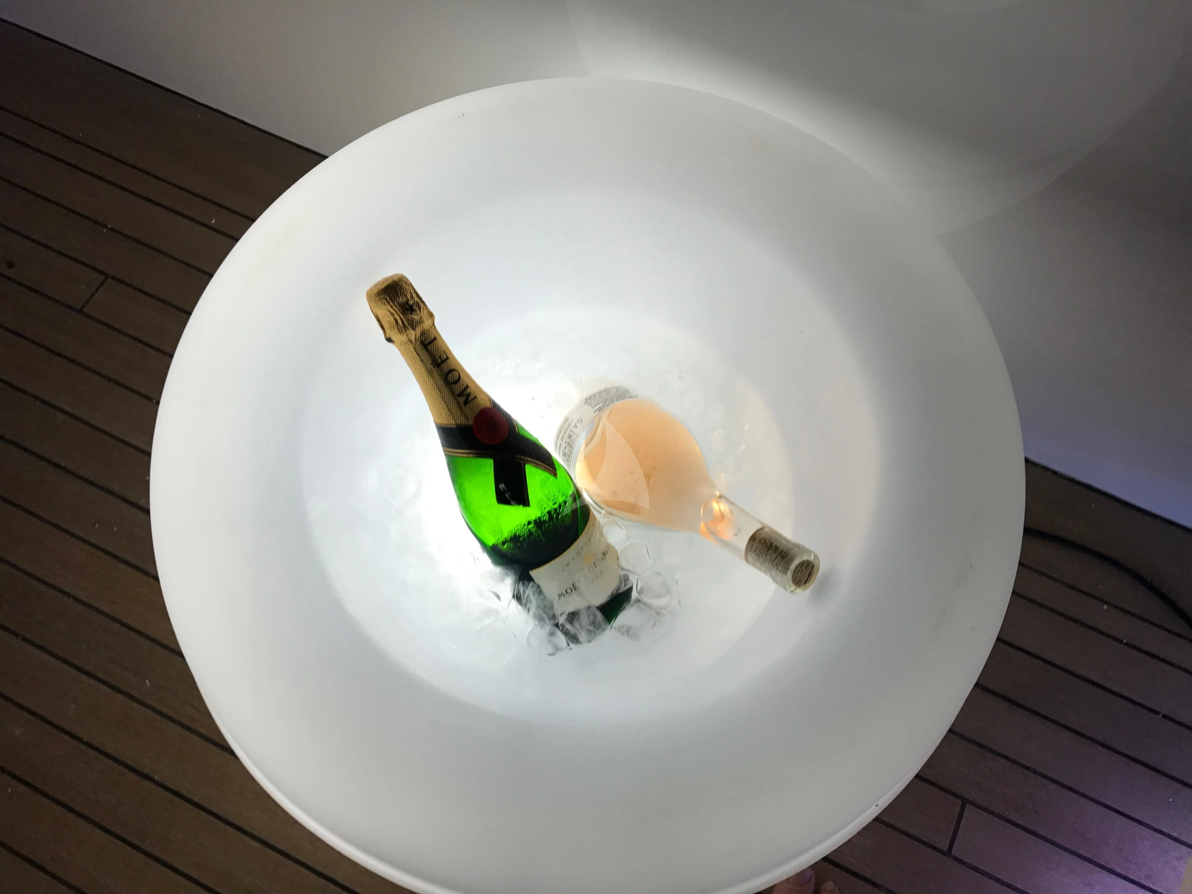 a bottle of champagne in a white bowl aboard VILLA SUL MARE Yacht for Sale