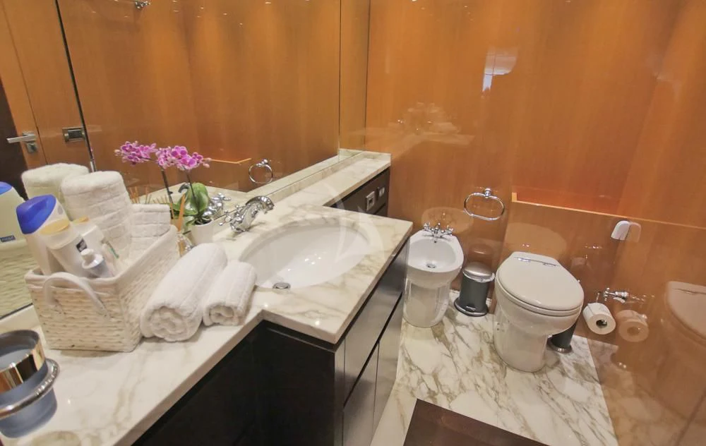 a bathroom with a sink toilet and a mirror aboard VILLA SUL MARE Yacht for Sale
