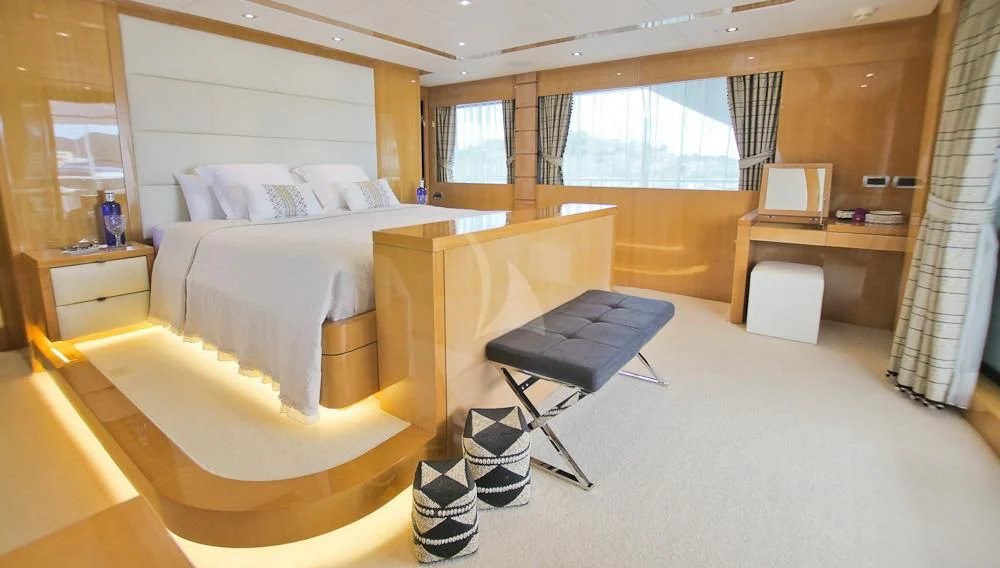 a bedroom with a bed and desk aboard VILLA SUL MARE Yacht for Sale