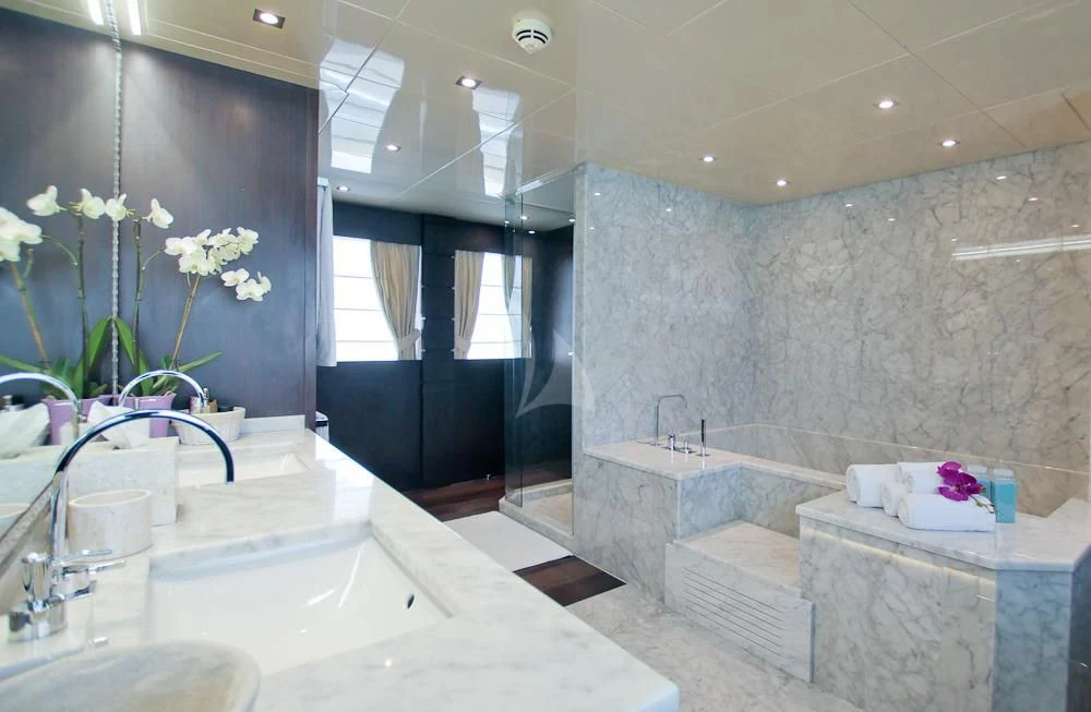 a bathroom with a tub sink and a sink aboard VILLA SUL MARE Yacht for Sale