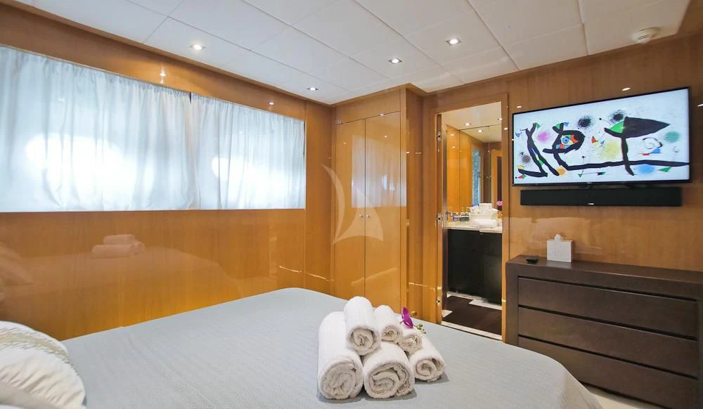 a hotel room with a tv on the wall aboard VILLA SUL MARE Yacht for Sale