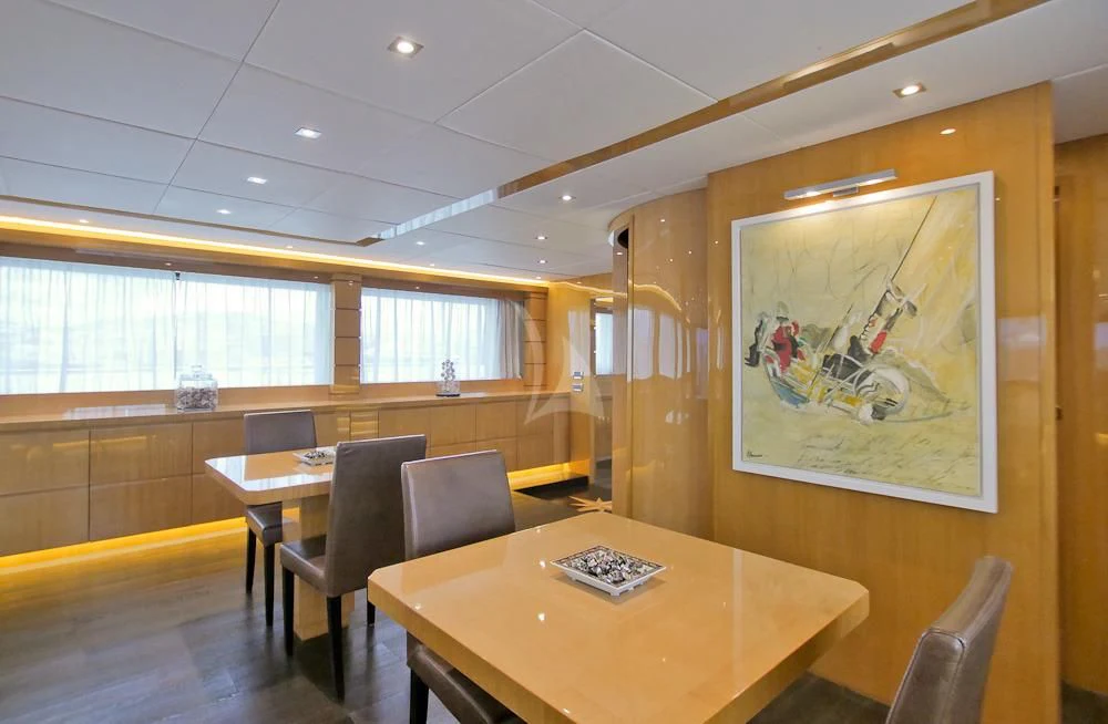 a room with tables and chairs aboard VILLA SUL MARE Yacht for Sale