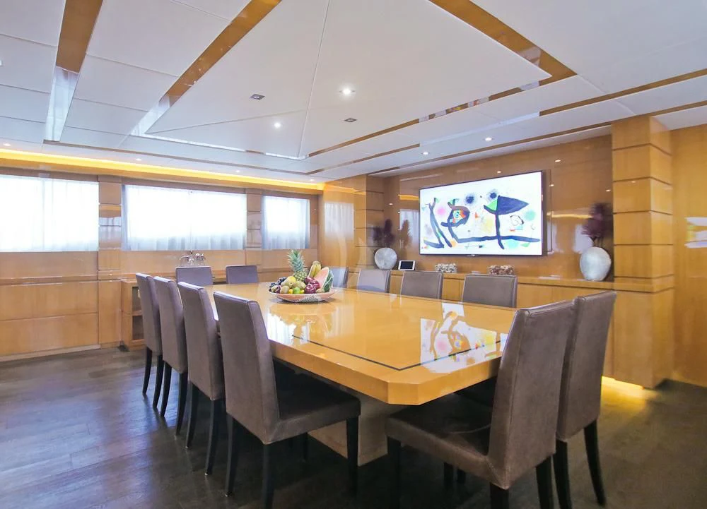 a large dining table with chairs aboard VILLA SUL MARE Yacht for Sale