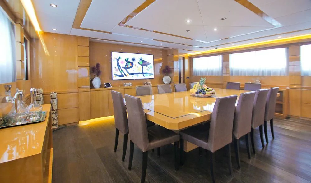 a dining room with a table and chairs aboard VILLA SUL MARE Yacht for Sale