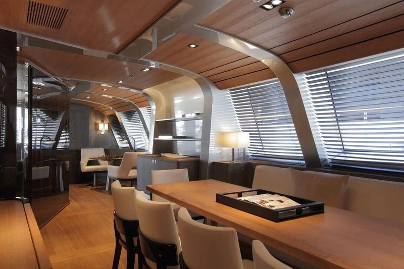 a room with tables and chairs aboard SEAHAWK Yacht for Sale