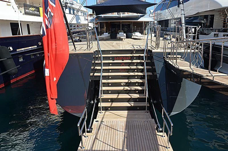 a boat with a red and blue flag on it aboard SEAHAWK Yacht for Sale