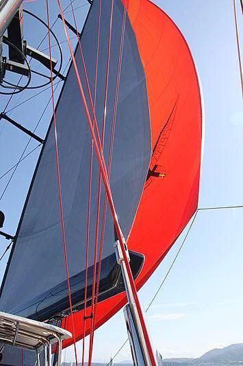 a red sailboat on a sunny day aboard SEAHAWK Yacht for Sale