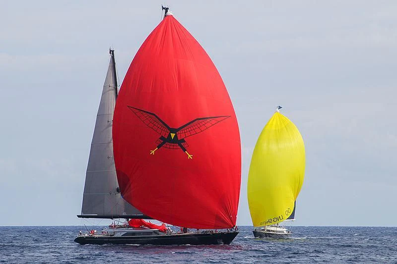 a couple of large red and yellow sailboats on the water aboard SEAHAWK Yacht for Sale