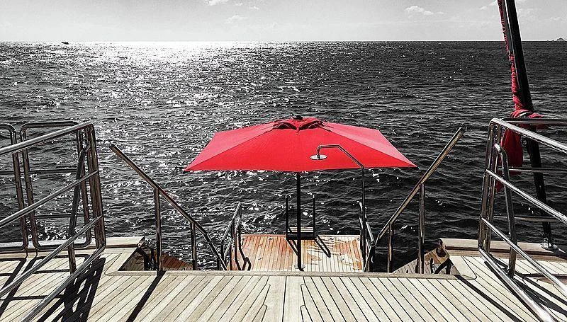 a red umbrella on a boat aboard SEAHAWK Yacht for Sale