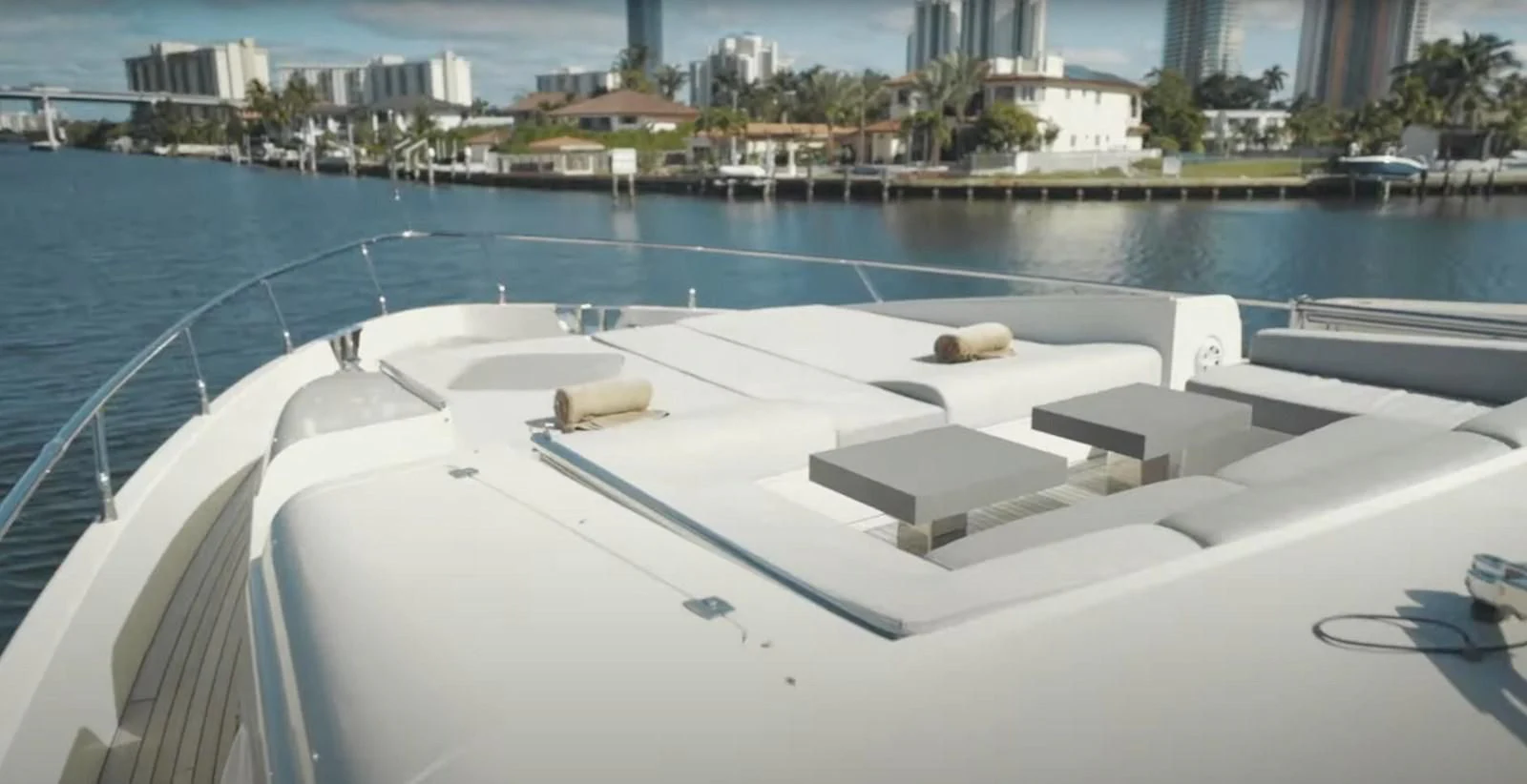 a pool with a deck and a building in the background aboard BT2 Yacht for Sale