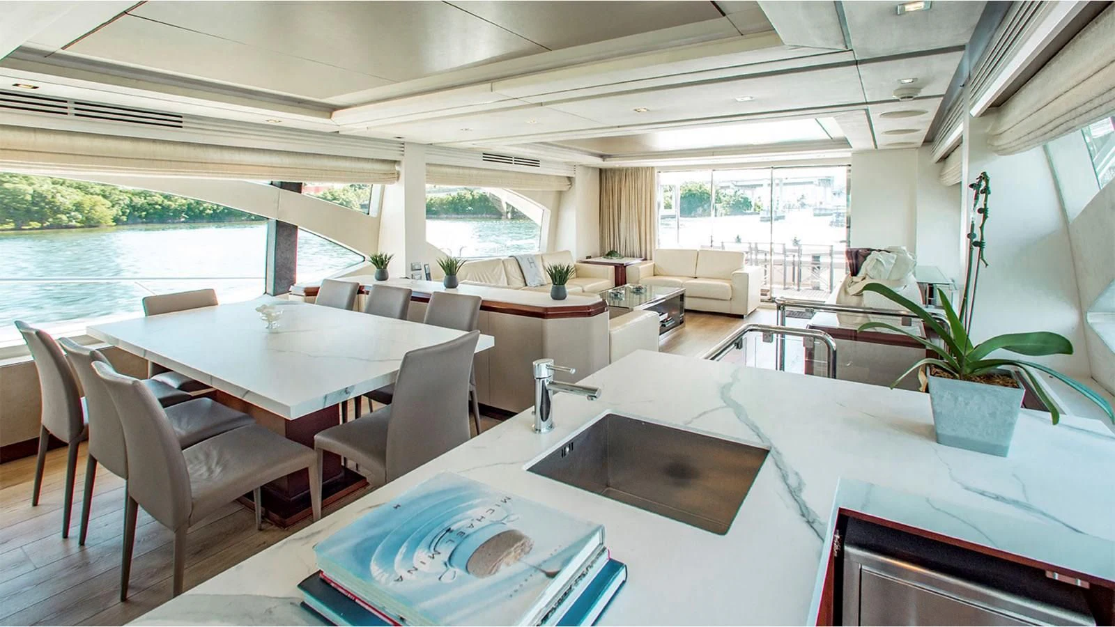 a room with tables and chairs aboard BT2 Yacht for Sale