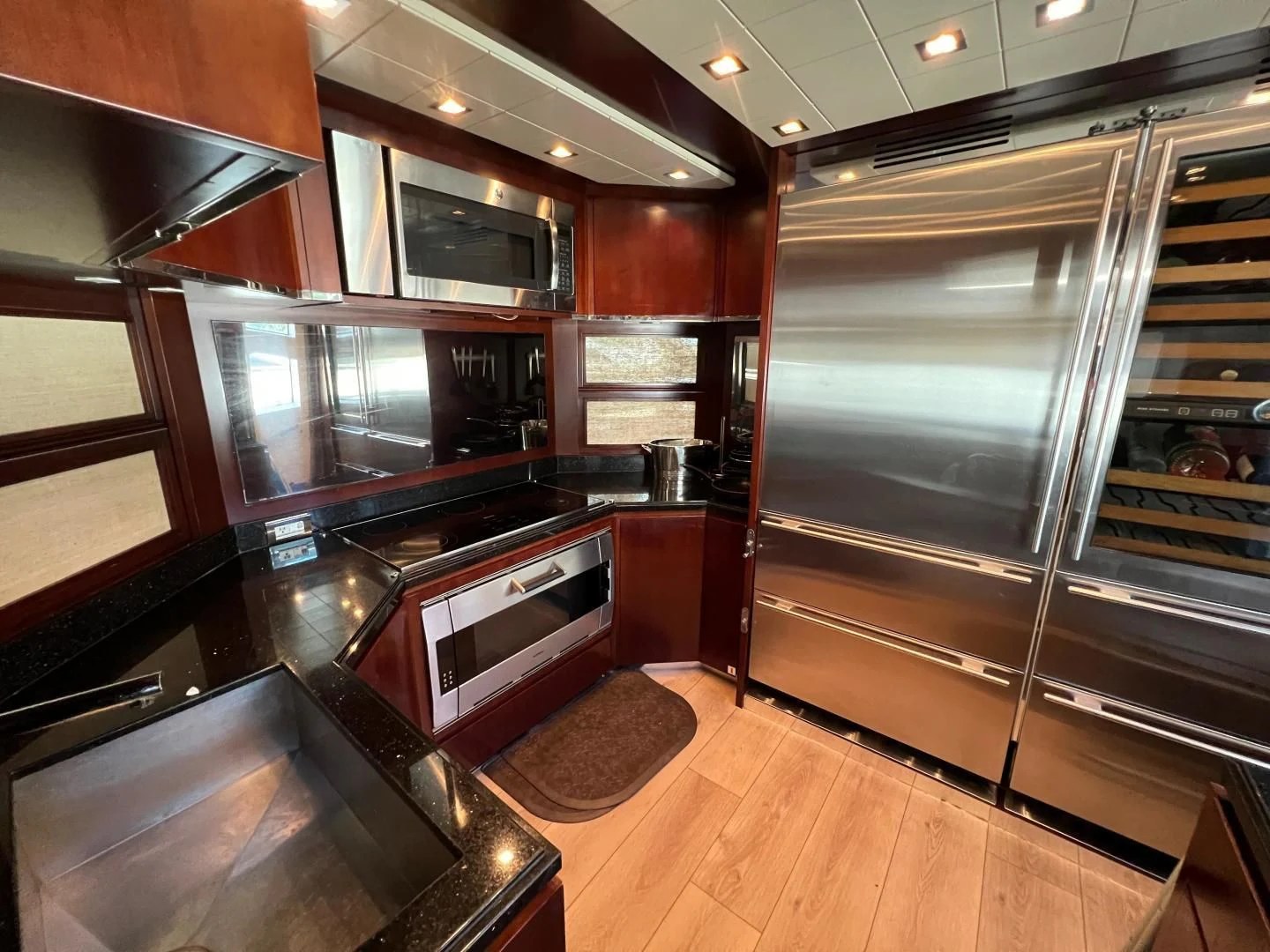 a kitchen with wooden cabinets aboard BT2 Yacht for Sale