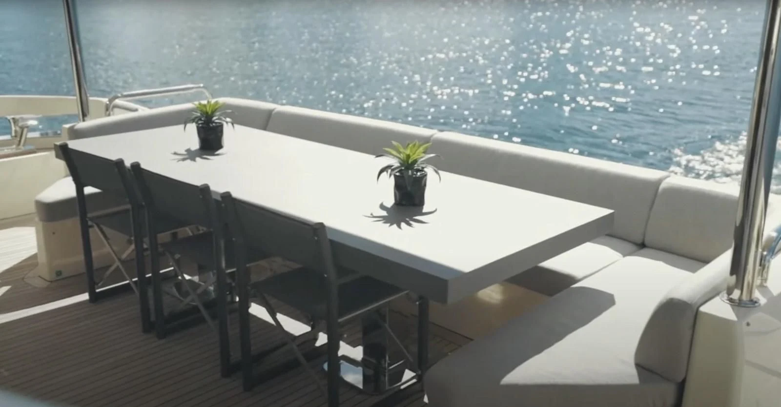 a white table with chairs around it aboard BT2 Yacht for Sale