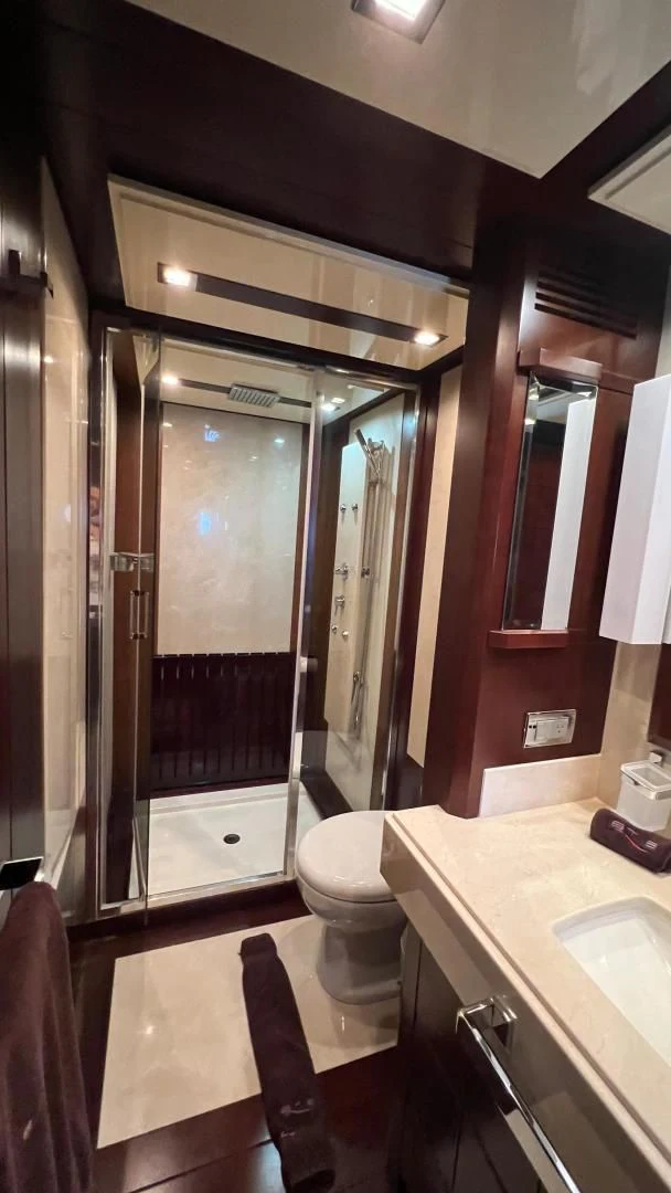 a bathroom with a glass shower aboard BT2 Yacht for Sale