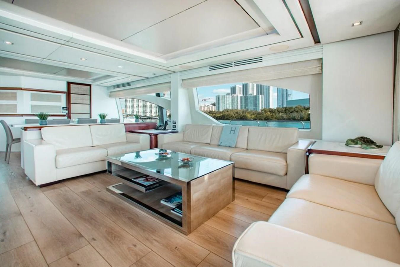a living room with a table and couches aboard BT2 Yacht for Sale