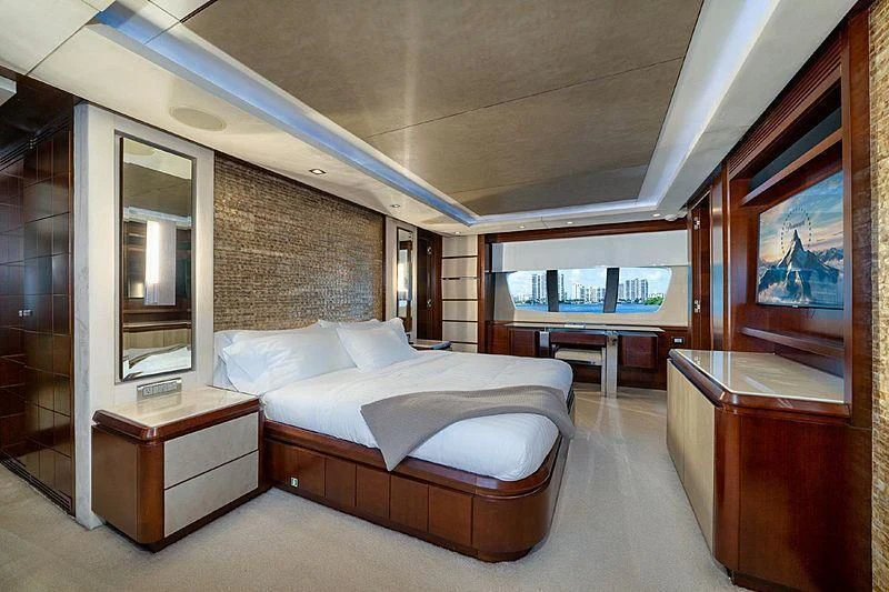 a bedroom with a bed and a desk aboard BT2 Yacht for Sale
