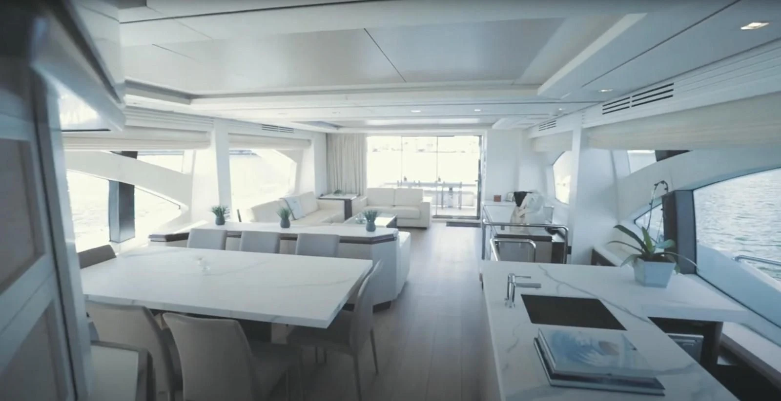 a room with white tables and chairs aboard BT2 Yacht for Sale
