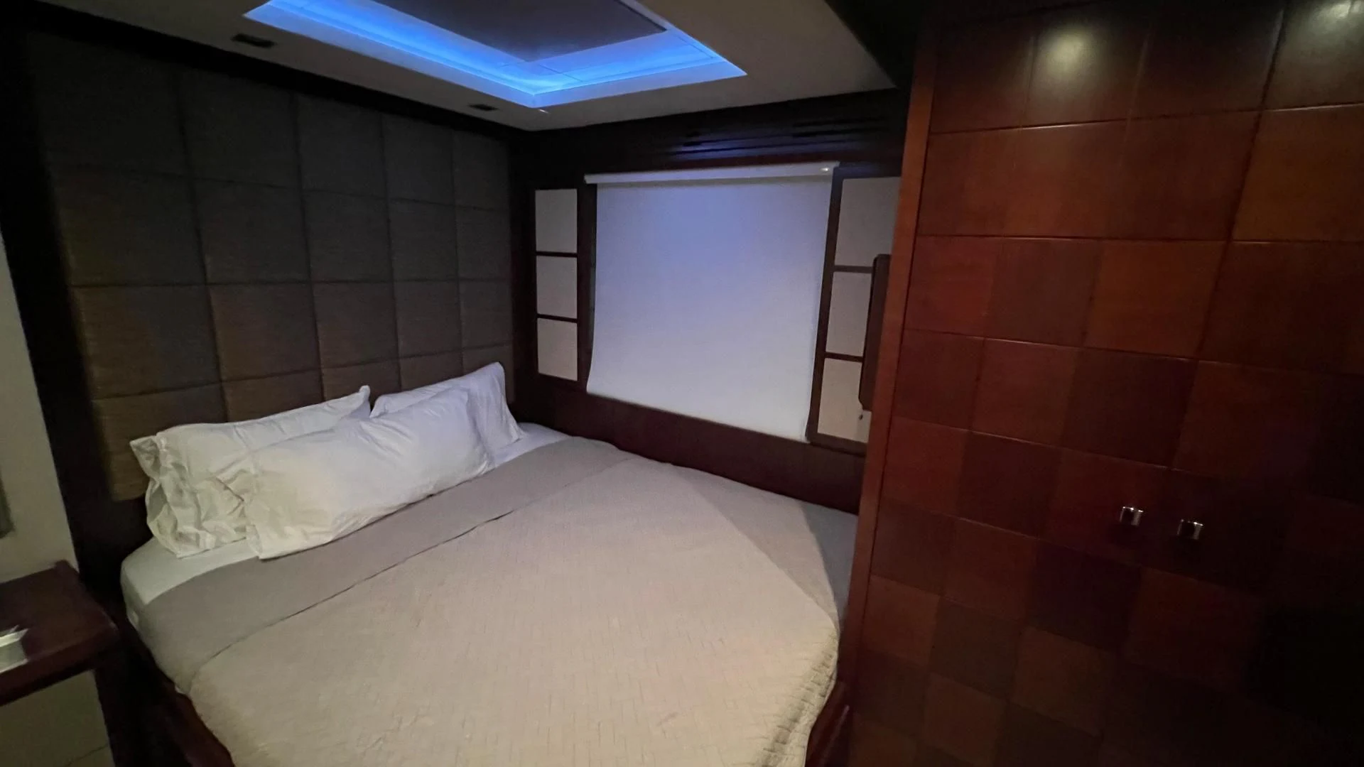 a room with a bed and a wall mounted television aboard BT2 Yacht for Sale